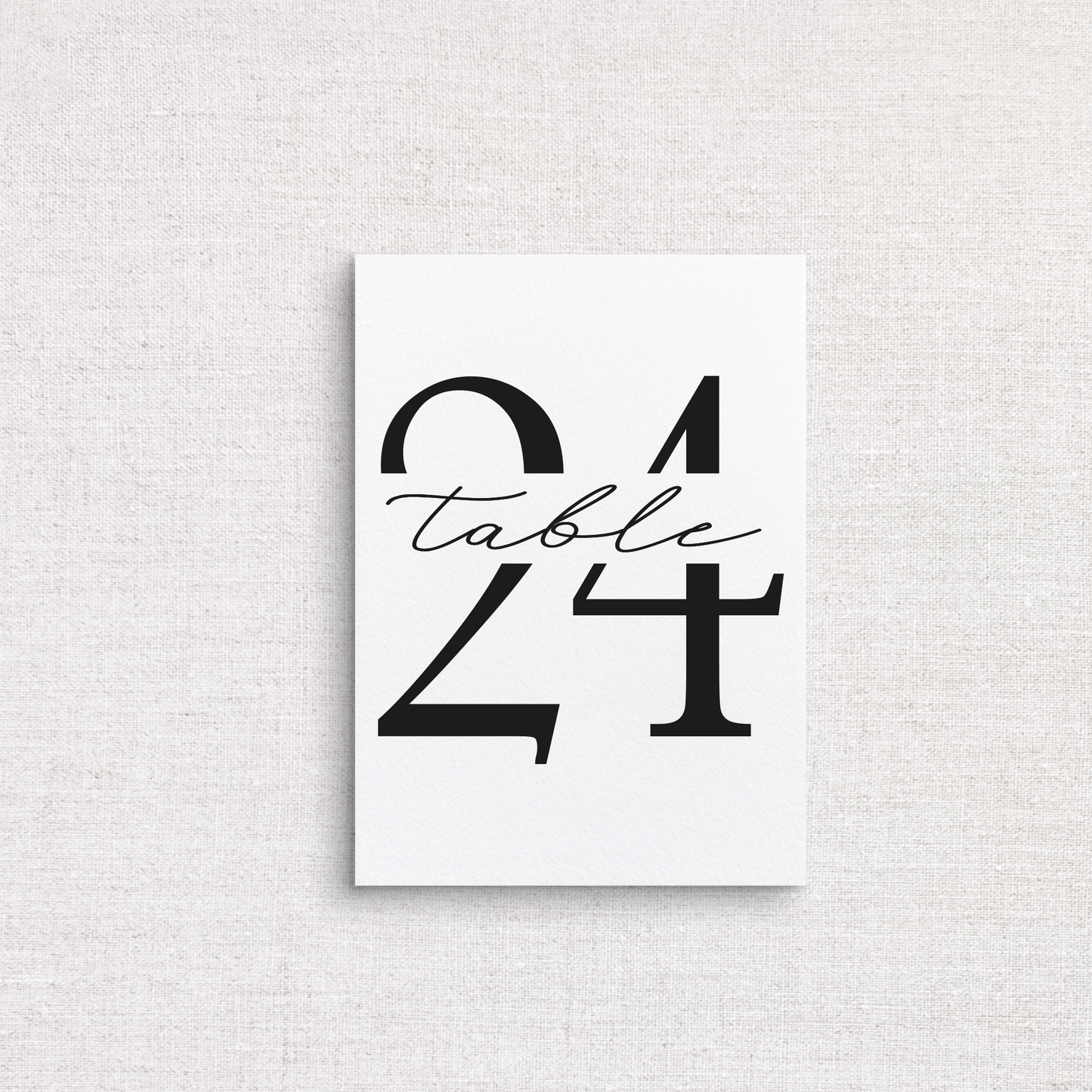 A minimalist white wedding table number print featuring the number 24 with the word 'table' in black cursive script, displayed against a light gray linen-textured background.