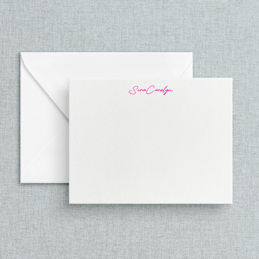 Custom letterpress stationery with the name written at the top, using a pink ink on white paper, accompanied by a white envelope.