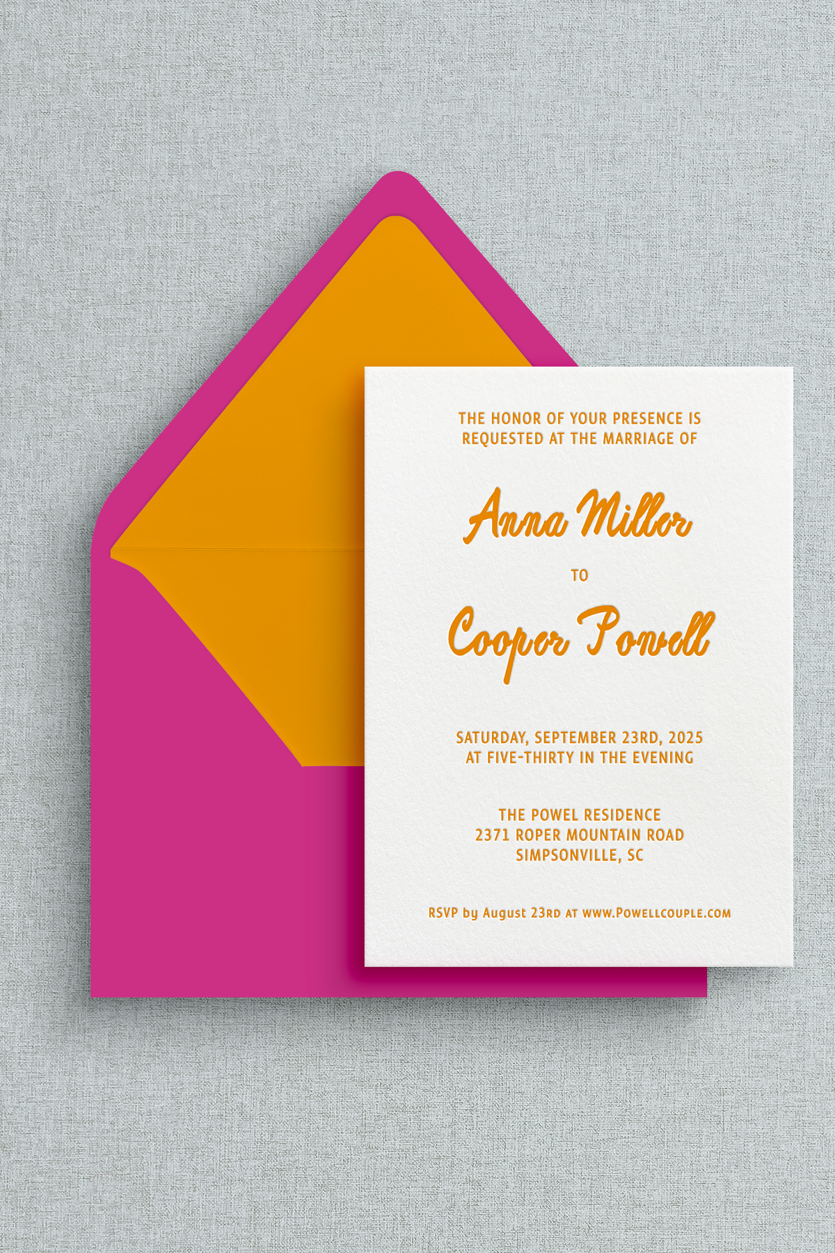 Custom letterpress wedding inviation with orange print and an orange and hot pink envelope. 