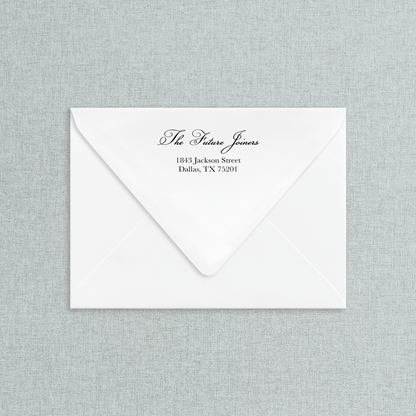 White envelope with black return address on a gray textured background