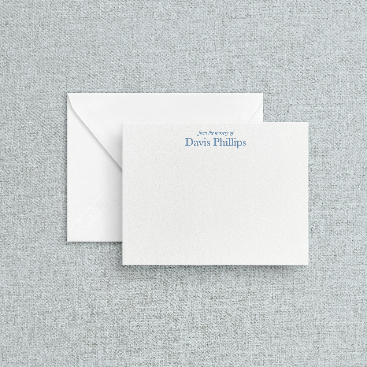 White card with letterpress print of "from the nursery of" in an italic serif font. Under it can be customized with the childs name. 