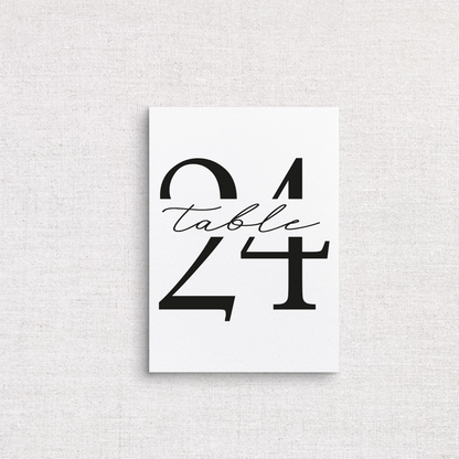 A minimalist white wedding table number print featuring the number 24 with the word 'table' in black cursive script, displayed against a light gray linen-textured background.