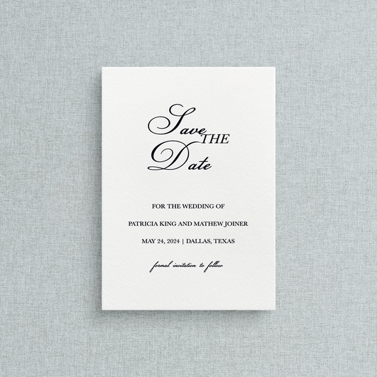Semi-custom letterpress Save the Date card with black text on a white background, placed on a gray textured surface.