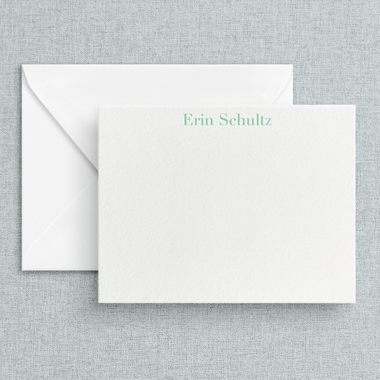 A custom letterpress stationery card with the name in a serif font printed in green. 