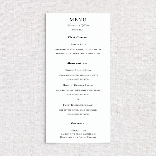 A vertical wedding menu card with elegant black script and serif typography on a white background, displayed against a light beige textured fabric backdrop. The menu includes sections for First Course, Main Entrees, and Desserts, personalized with the names and the wedding date.