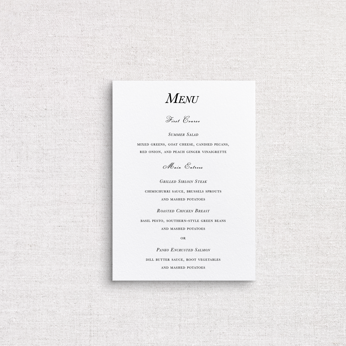 A traditional wedding menu card with elegant black script and serif text on a clean white background, displayed against a textured light gray fabric backdrop.