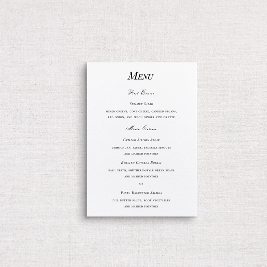 A traditional wedding menu card with elegant black script and serif text on a clean white background, displayed against a textured light gray fabric backdrop.
